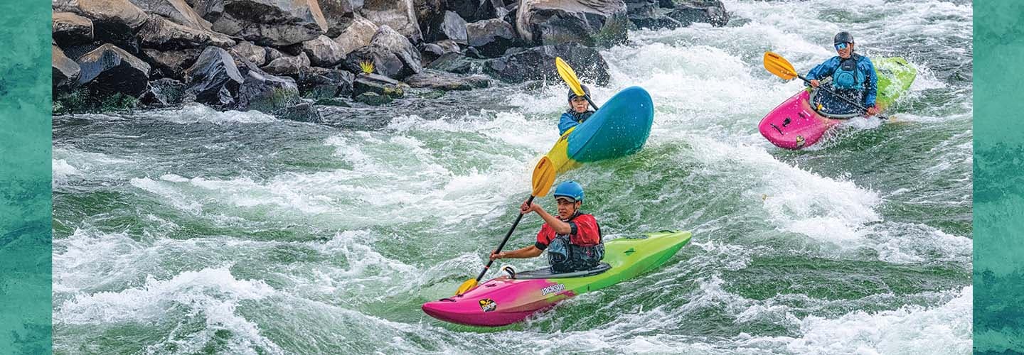 Photo of people kayaking down treacherous river