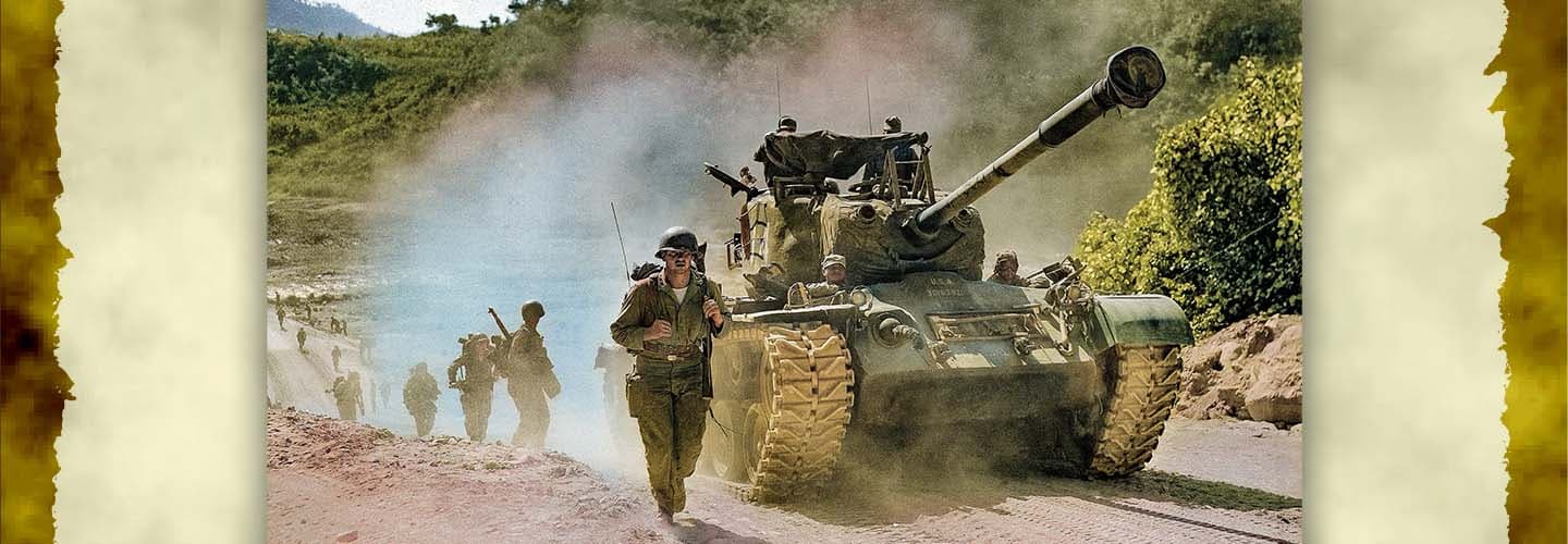 Image of soldiers walking alongside a tank